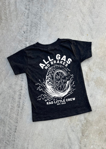 Black t-shirt with white graphic and text on a gray concrete surface